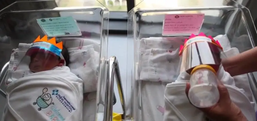 newborn wearing pollution face shield